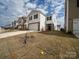 Two-story home with white siding, dark shutters, a two-car garage, and a manicured front lawn at 14217 Wilson Mac Ln, Charlotte, NC 28278