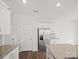 Bright kitchen boasts stainless steel appliances, granite countertops, and modern white cabinetry at 14217 Wilson Mac Ln, Charlotte, NC 28278