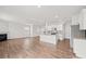 Open concept kitchen with an island featuring a sink, modern appliances, and white cabinets at 14217 Wilson Mac Ln, Charlotte, NC 28278