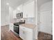 Modern kitchen with granite countertops, stainless steel appliances, and white cabinets at 14217 Wilson Mac Ln, Charlotte, NC 28278