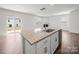 Kitchen island with granite countertop and stainless steel sink, complemented by hardwood floors at 14217 Wilson Mac Ln, Charlotte, NC 28278