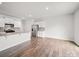 Modern kitchen with white cabinets, stainless steel appliances, granite countertops, and hardwood floors at 14217 Wilson Mac Ln, Charlotte, NC 28278