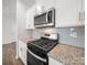 Modern kitchen with stainless steel appliances, white cabinets and granite countertops at 14217 Wilson Mac Ln, Charlotte, NC 28278
