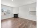 Cozy living room featuring hardwood floors, a fireplace, and large windows for natural light at 14217 Wilson Mac Ln, Charlotte, NC 28278
