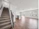 Bright open concept living room with hardwood floors, stairs and plenty of natural light at 14217 Wilson Mac Ln, Charlotte, NC 28278
