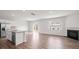 Bright living room and kitchen area with fireplace and hardwood floors, and a sliding door to the backyard at 14217 Wilson Mac Ln, Charlotte, NC 28278
