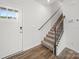Inviting entryway showcases a carpeted staircase with a dark wood handrail at 14217 Wilson Mac Ln, Charlotte, NC 28278