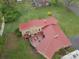 Aerial view of house featuring a red metal roof, patio, and surrounding landscaping at 143 W College St, Stanley, NC 28164