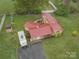 Aerial view of home with a red metal roof and spacious yard at 143 W College St, Stanley, NC 28164