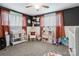 Bright bedroom with a ceiling fan, white wainscotting, and playful decor at 143 W College St, Stanley, NC 28164
