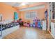 Bright room with a big window, hardwood floors and peach colored walls at 143 W College St, Stanley, NC 28164