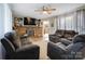 Inviting living room with a stone fireplace, built-in shelves, and comfortable seating at 143 W College St, Stanley, NC 28164