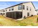 Home exterior featuring a screened in patio area with a grill and grassy backyard at 154 Shields Dr, Lincolnton, NC 28092