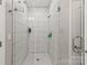 Bathroom featuring tiled walls, a glass shower door, and modern fixtures at 154 Shields Dr, Lincolnton, NC 28092