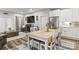 A dining room adjacent to a living room, featuring a fireplace, television, and stainless steel refrigerator at 154 Shields Dr, Lincolnton, NC 28092