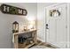 Charming entryway with a wooden table, decorative lamp, and a 'Home' sign, creating a cozy atmosphere at 154 Shields Dr, Lincolnton, NC 28092