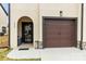 Charming exterior featuring an arched front door and a stylish brown garage door at 154 Shields Dr, Lincolnton, NC 28092