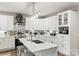 Bright kitchen featuring white cabinets, a large island, stainless steel appliances, and stylish decor at 154 Shields Dr, Lincolnton, NC 28092