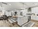Bright, open kitchen with stainless appliances, island sink, and dining area flowing into the living room at 154 Shields Dr, Lincolnton, NC 28092