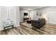 Spacious room with wood flooring, a comfortable grey couch, and a mounted television at 154 Shields Dr, Lincolnton, NC 28092