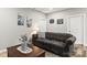 Comfortable living room featuring a tufted couch, decorative wall art and nice floors at 154 Shields Dr, Lincolnton, NC 28092