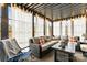 Relaxing sunroom with ample seating, natural light, and stylish decor and lighting at 154 Shields Dr, Lincolnton, NC 28092