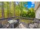 Relaxing outdoor deck with dining table and seating surrounded by trees at 1628 Rosegate Ln, Stanfield, NC 28163