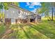 Spacious backyard view featuring a deck, brick foundation, and lush greenery at 1628 Rosegate Ln, Stanfield, NC 28163