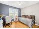 Bright bedroom offering hardwood floors, lots of natural light, and a cozy single bed at 1628 Rosegate Ln, Stanfield, NC 28163
