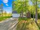 Inviting single-story home with a two-car garage, set amidst mature trees and a green lawn at 1628 Rosegate Ln, Stanfield, NC 28163