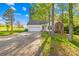 This single-Gathering home features an attached garage, a well-maintained lawn, and a paved driveway at 1628 Rosegate Ln, Stanfield, NC 28163