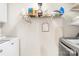 This laundry room is equipped with storage shelving, a washing machine and a clothes dryer at 1628 Rosegate Ln, Stanfield, NC 28163