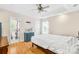 Bright main bedroom featuring a ceiling fan, a tray ceiling, and an ensuite bathroom with shower at 1628 Rosegate Ln, Stanfield, NC 28163