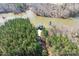 Breathtaking aerial view showcasing a stunning home nestled among lush trees and waterfront at 233 Conifer Way, Shelby, NC 28150