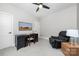 Neutral bedroom featuring a ceiling fan, desk area and reading chair at 233 Conifer Way, Shelby, NC 28150