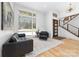Bright foyer featuring a staircase, a large window, and hardwood floors at 233 Conifer Way, Shelby, NC 28150