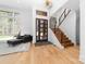 Bright foyer featuring a staircase, a large window, and hardwood floors at 233 Conifer Way, Shelby, NC 28150