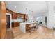Modern kitchen featuring wood cabinets, a large island with seating, and stainless steel appliances at 233 Conifer Way, Shelby, NC 28150