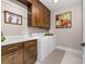 Well-lit laundry room features cabinetry, folding counter, and modern washer and dryer for efficient chores at 233 Conifer Way, Shelby, NC 28150