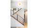 Modern staircase featuring hardwood steps, metal railing, and neutral paint at 233 Conifer Way, Shelby, NC 28150