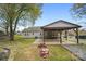Exterior of home displaying a covered area attached to the back of the house and fire pit at 2420 Kannapolis Hwy, Concord, NC 28027