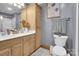 This bathroom features natural wood cabinets and well lit vanity mirror at 2420 Kannapolis Hwy, Concord, NC 28027