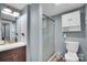 A cozy bathroom features a glass enclosed shower, a white toilet, and vanity with neutral toned walls at 2420 Kannapolis Hwy, Concord, NC 28027