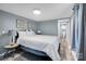 Comfortable bedroom featuring neutral color palette, updated flooring, and ensuite bathroom at 2420 Kannapolis Hwy, Concord, NC 28027