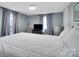 Inviting bedroom featuring a neutral color palette, updated flooring, and comfortable furniture at 2420 Kannapolis Hwy, Concord, NC 28027