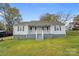 Cozy home with a welcoming front porch, blue shutters, and well-manicured lawn at 2420 Kannapolis Hwy, Concord, NC 28027