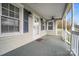 Charming covered front porch with ceiling fan, white railings, and blue shutters at 2420 Kannapolis Hwy, Concord, NC 28027