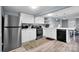 Modern kitchen featuring stainless steel appliances, updated cabinets and access to the living space at 2420 Kannapolis Hwy, Concord, NC 28027