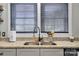 Bright kitchen featuring granite countertops, stainless steel sink, and modern faucet at 2420 Kannapolis Hwy, Concord, NC 28027