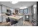 Updated kitchen featuring stainless steel appliances, granite countertops, and a center island with seating at 2420 Kannapolis Hwy, Concord, NC 28027